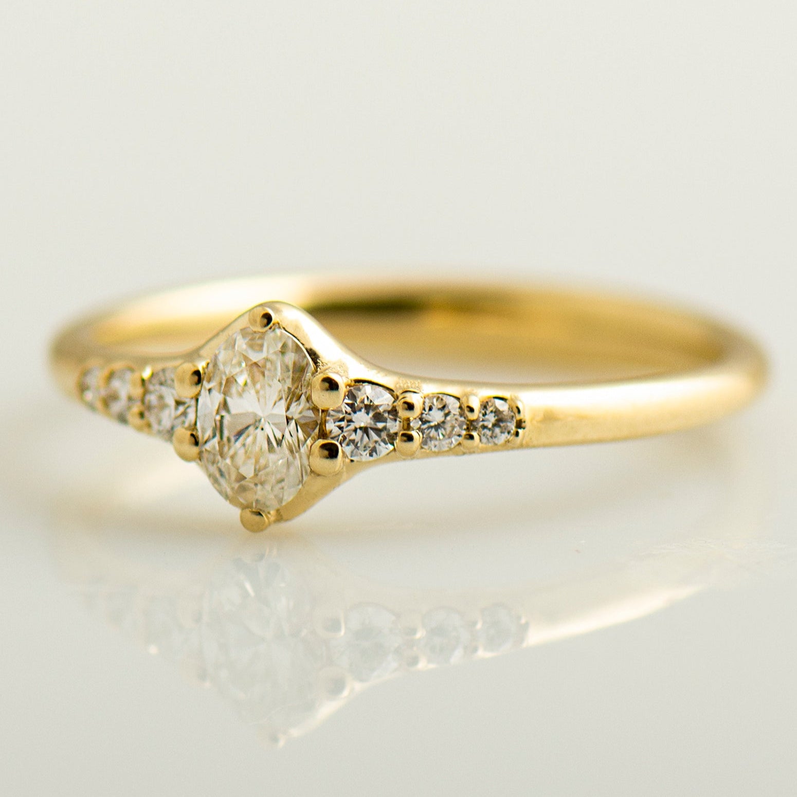 Tapered tiny oval diamond ring